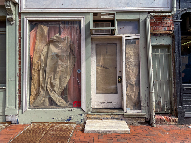 Am abandoned storefront covered with different draped papers by Stella Untalan